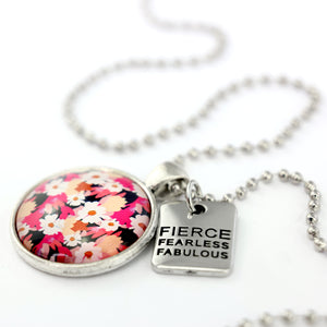 Circle pendant necklace in vintage silver with 'fierce fearless fabulous' charm, bright pink floral print. Fundraiser for the national breast cancer foundation.