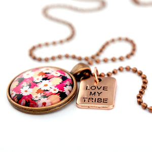 Circle pendant necklace in vintage copper with 'LOVE MY TRIBE' charm, bright pink floral print. Fundraiser for the national breast cancer foundation.