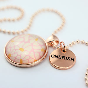 Circle pendant necklace in rose gold with 'cherish' charm, floral print. Fundraiser for the national breast cancer foundation.