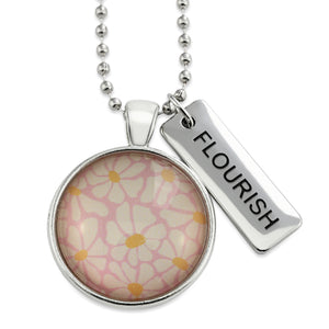 Circle pendant necklace in silver with 'flourish' charm, floral print. Fundraiser for the national breast cancer foundation.