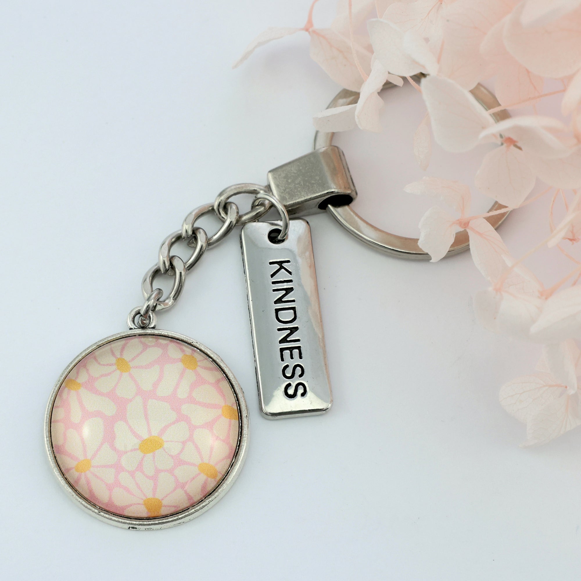 Circle pendant keychain in vintage silver with 'kindness' charm, floral print. Fundraiser for the national breast cancer foundation.