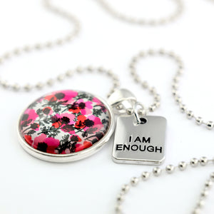 Pink print silver circle pendant necklace with ball chain and 'I Am Enough' charm. This product is raising money for the National Breast Cancer Foundation. 