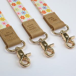 cream floral teacher lanyard with gold clip. Choose from so loved, teach love inspire or you got this. 