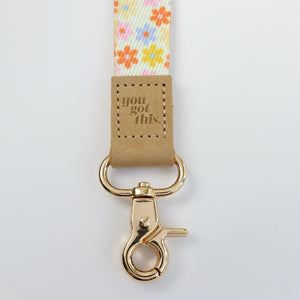 cream floral teacher lanyard with gold clip. Choose from so loved, teach love inspire or you got this. 