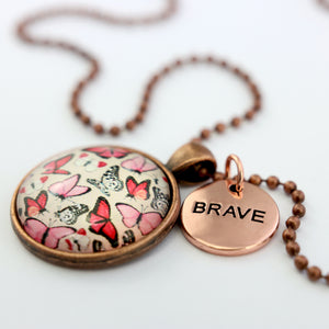 Pink floral print circle vintage red copper pendant necklace with ball chain with rose gold circle shape 'brave' charm. Fundraising product for the National Breast Cancer Foundation. 