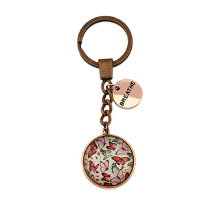 Pink floral print vintage copper circle pendant keychain with rose gold circle shape 'breathe' charm. Fundraising product for the National Breast Cancer Foundation. 