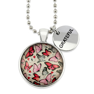 Pink floral print silver circle pendant necklace with ball chain with rose gold circle shape 'grateful' charm. Fundraising product for the National Breast Cancer Foundation. 