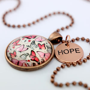 Pink floral print circle vintage red copper pendant necklace with ball chain with rose gold circle shape 'hope' charm. Fundraising product for the National Breast Cancer Foundation. 