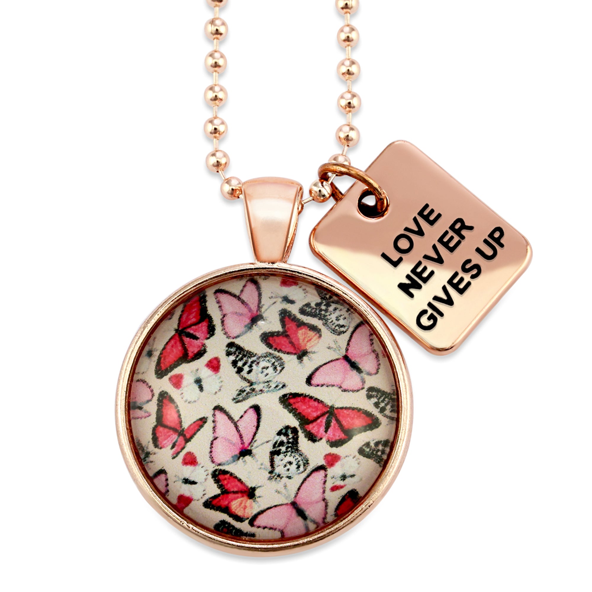 Pink floral print circle pendant rose gold necklace with ball chain with 'love never gives up' word charm. Fundraising product for the National Breast Cancer Foundation. 