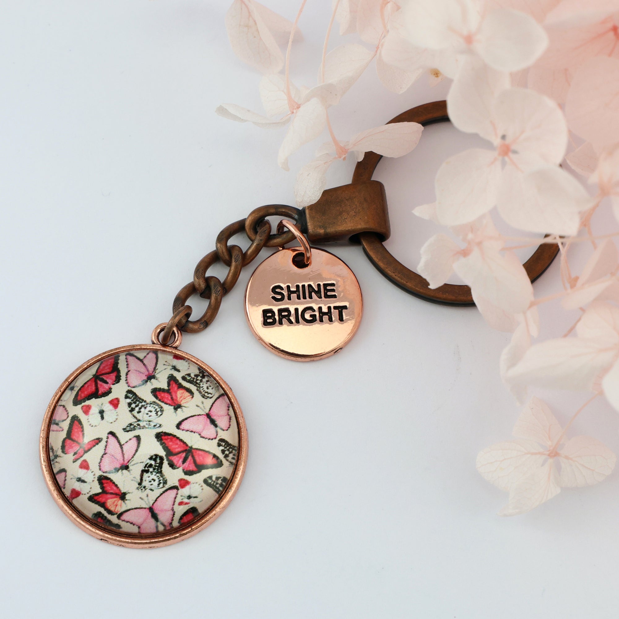  Pink floral print vintage copper circle pendant keychain with rose gold circle shape 'shine bright' charm. Fundraising product for the National Breast Cancer Foundation. 