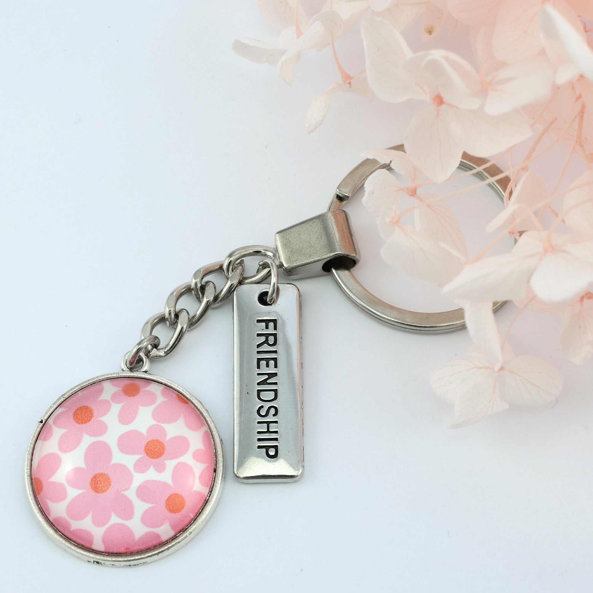 Pink floral print vintage silver circle pendant keychain with 'friendship' charm. A product that fundraises for the National Breast Cancer Foundation. 