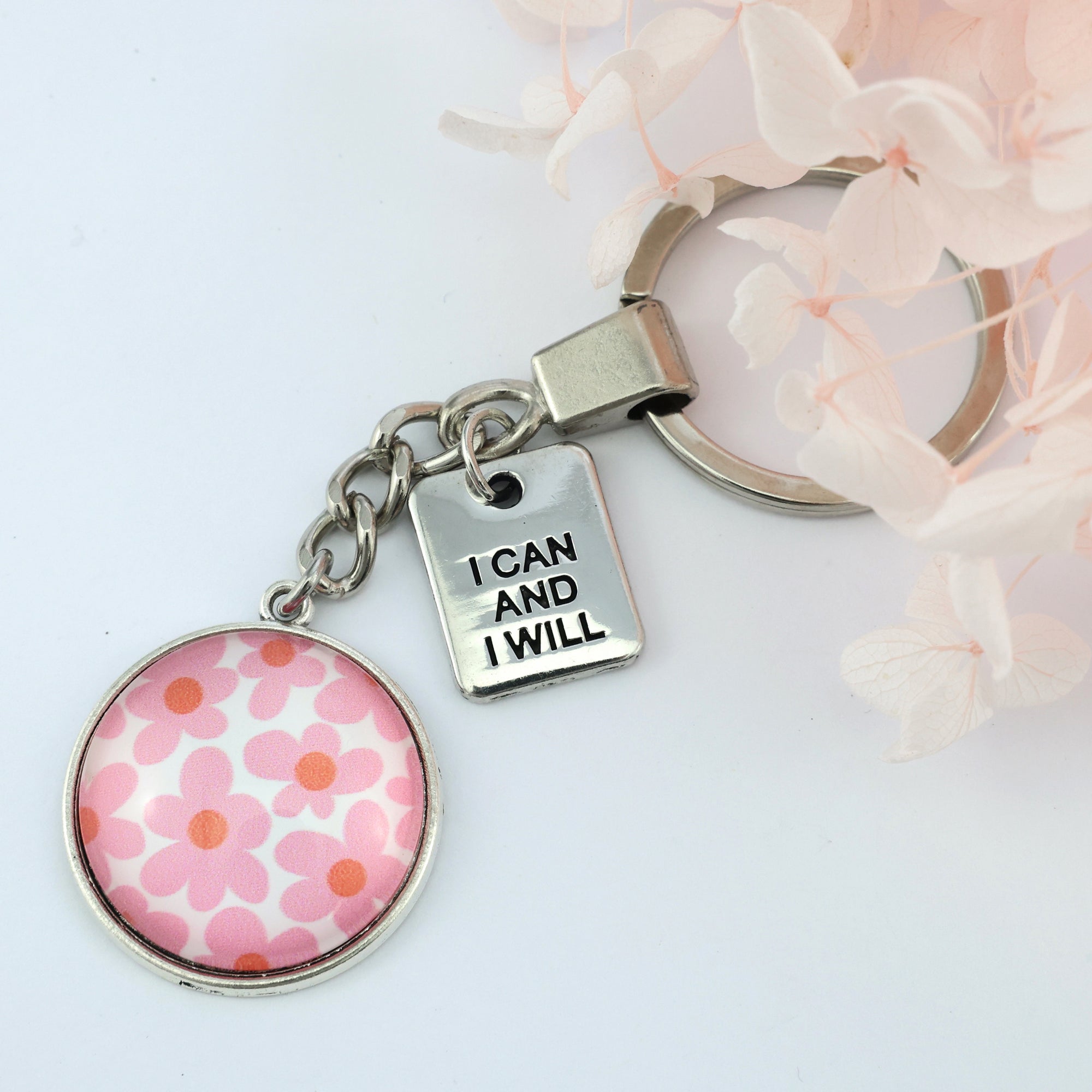 Pink floral print vintage silver circle pendant keychain with 'I Can And I Will' charm. A product that fundraises for the National Breast Cancer Foundation. 