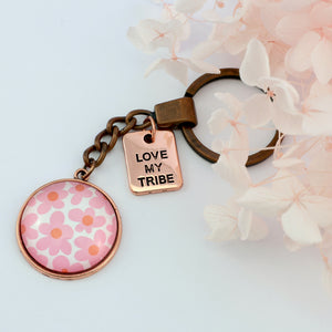 Pink floral print vintage red copper circle keychain with 'love my tribe' charm. A product that fundraises for the National Breast Cancer Foundation. 