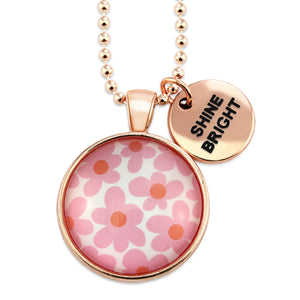 Pink floral print rose gold circle pendant necklace with 'courageous' charm. A product that fundraises for the National Breast Cancer Foundation. 