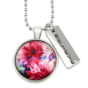 Pink floral print silver circle pendant necklace with 'believe' charm. A product that fundraises for the National Breast Cancer Foundation. 