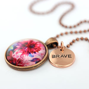 Pink floral print vintage red copper circle pendant necklace with rose gold 'brave' charm. A product that fundraises for the National Breast Cancer Foundation. 