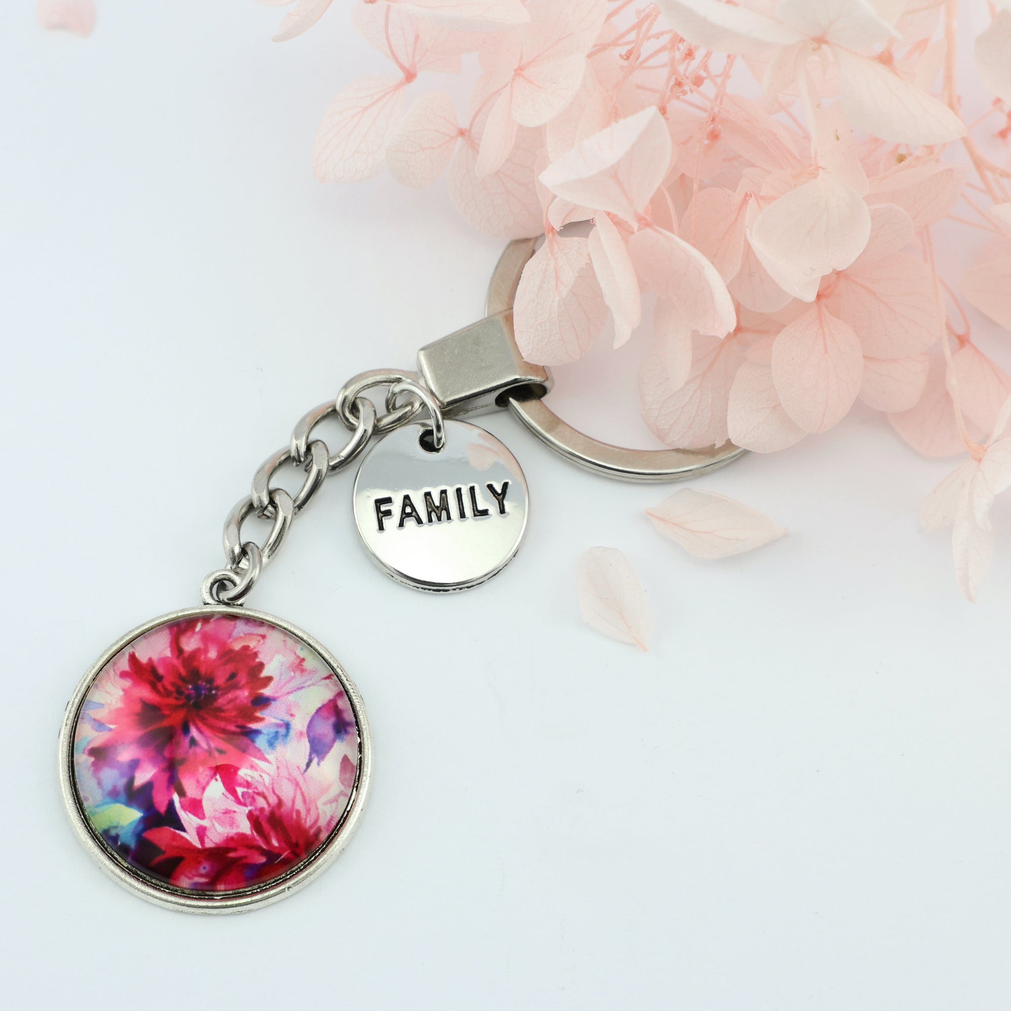 Pink floral print silver circle pendant keychain with 'family' charm. A product that fundraises for the National Breast Cancer Foundation. 