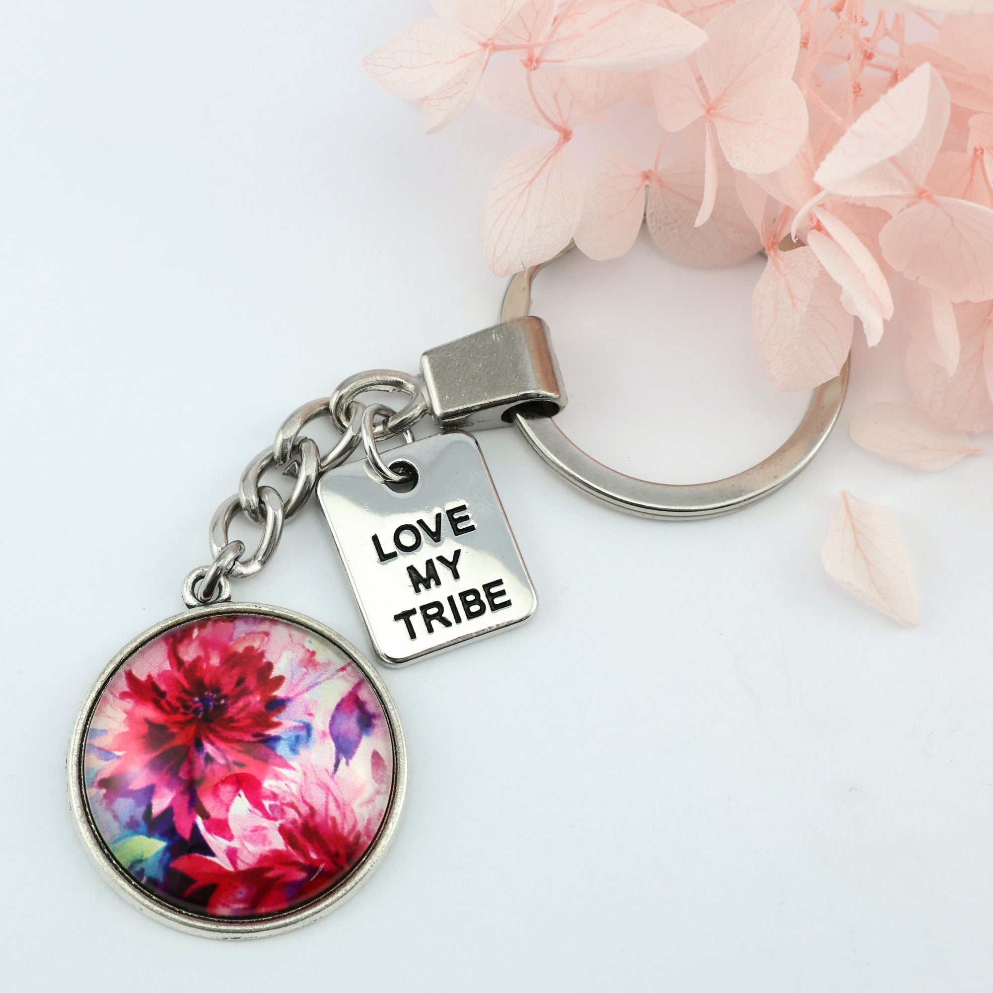 Pink floral print silver circle pendant keychain with 'family' charm. A product that fundraises for the National Breast Cancer Foundation. 