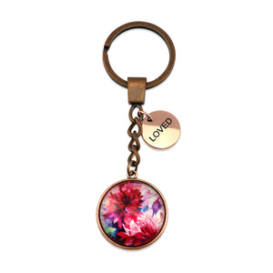 Pink floral print vintage copper circle pendant keychain with 'loved' charm. A product that fundraises for the National Breast Cancer Foundation. 