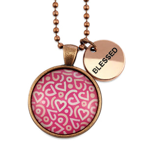 Pink heart print vintage red copper circle pendant necklace with 'blessed' charm. A fundraising product for the national breast cancer foundation. 