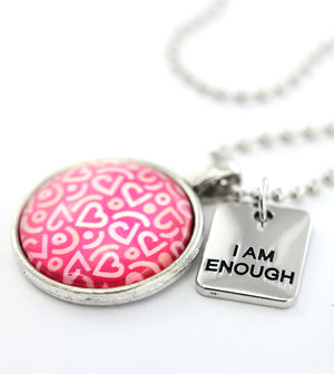 Pink heart print silver circle pendant necklace with 'I Am Enough' charm. A fundraising product for the national breast cancer foundation. 