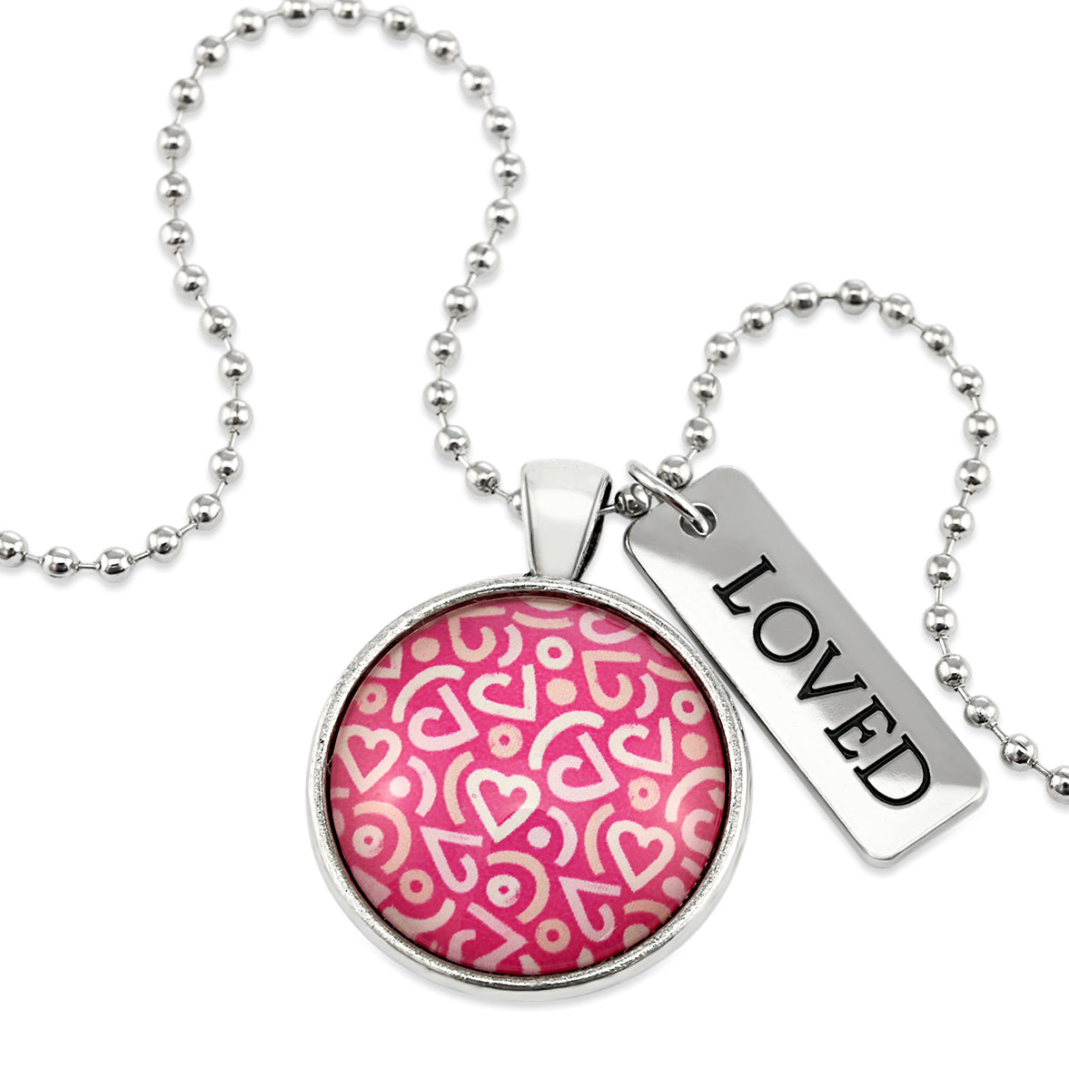 Pink heart print silver circle pendant necklace with 'loved' charm. A fundraising product for the national breast cancer foundation. 