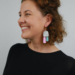 woman wearing large statement dangle earrings