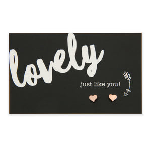 Tiny heart shaped earring stud on a card that says 'Lovely just like you' materials are plated zinc alloy. 