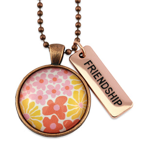 Pink floral print circle pendant vintage copper ball chain necklace with rose gold 'friendship' word charm. Fundraising product for the National Breast Cancer Foundation. 