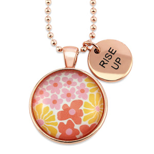 Pink floral print circle pendant silver ball chain necklace with rose gold 'rise up' word charm. Fundraising product for the National Breast Cancer Foundation. 