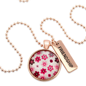 Pink floral print circle pendant rose gold ball chain necklace with rose gold 'friendship' word charm. Fundraising product for the National Breast Cancer Foundation. 