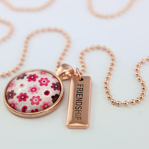 Pink floral print circle pendant rose gold ball chain necklace with rose gold 'friendship' word charm. Fundraising product for the National Breast Cancer Foundation. 