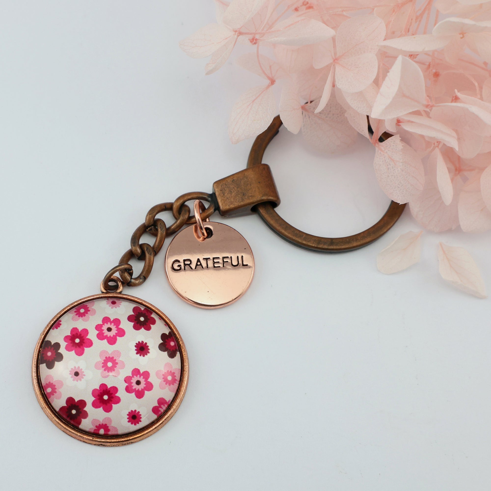 Pink floral print circle keychain pendant rose gold 'grateful' word charm. Fundraising product for the National Breast Cancer Foundation. 