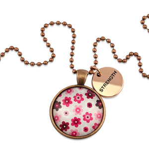 Pink floral print circle pendant vintage red copper ball chain necklace with rose gold 'strength' word charm. Fundraising product for the National Breast Cancer Foundation. 