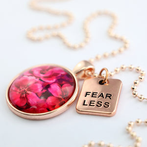 Circle pendant necklace in rose gold with 'fearless' charm, floral print, ball chain necklace. Fundraiser for the national breast cancer foundation.