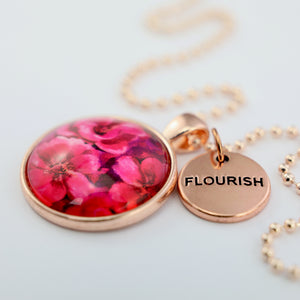 Circle pendant necklace in rose gold with 'flourish' charm, floral print, ball chain necklace. Fundraiser for the national breast cancer foundation.