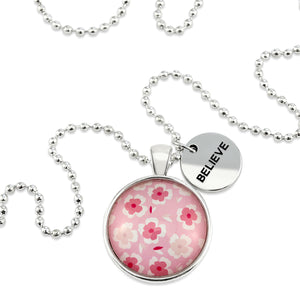 Pink floral print circle pendant silver ball chain necklace with silver 'believe' word charm. Fundraising product for the National Breast Cancer Foundation. 