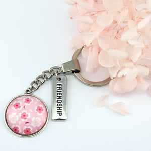 Circle pendant keyring in vintage silver with 'friendship ' charm, soft pink floral print. Fundraiser for the national breast cancer foundation.