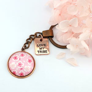 Circle pendant keyring in vintage copper with 'love my tribe ' charm, soft pink floral print. Fundraiser for the national breast cancer foundation.