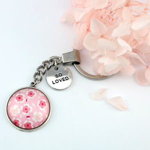 Circle pendant keyring in vintage silver with 'so loved ' charm, soft pink floral print. Fundraiser for the national breast cancer foundation.