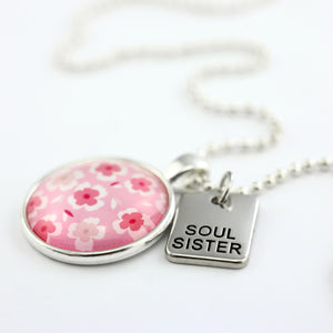 Pink floral print circle pendant silver ball chain necklace with silver 'soul sister' word charm. Fundraising product for the National Breast Cancer Foundation. 