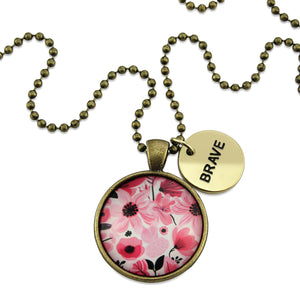 Pink floral print circle pendant vintage gold ball chain necklace with gold 'brave' word charm. Fundraising product for the National Breast Cancer Foundation. 