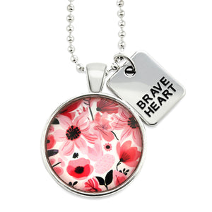 Pink floral print circle pendant silver ball chain necklace with silver 'brave heart' word charm. Fundraising product for the National Breast Cancer Foundation. 