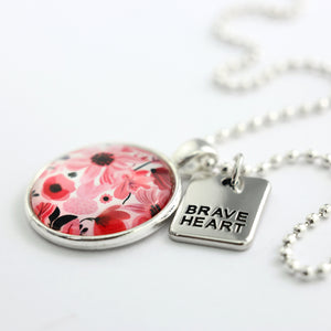 Pink floral print circle pendant silver ball chain necklace with silver 'brave heart' word charm. Fundraising product for the National Breast Cancer Foundation. 