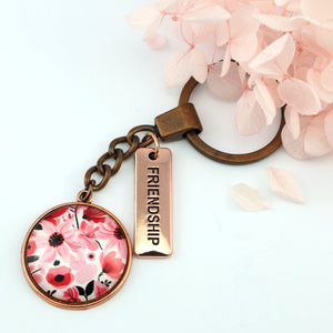 Circle pendant keyring in vintage copper with 'friendship' charm, pop pink floral print. Fundraiser for the national breast cancer foundation.