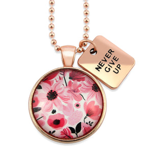 Pink floral print circle pendant rose gold ball chain necklace with never give up word charm. Fundraising product for the National Breast Cancer Foundation. 