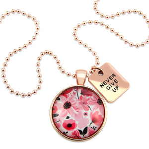 Pink floral print circle pendant rose gold ball chain necklace with never give up word charm. Fundraising product for the National Breast Cancer Foundation. 