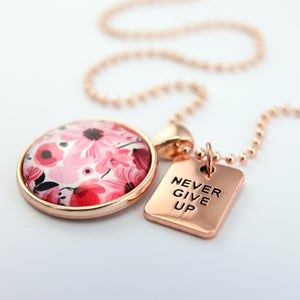 Pink floral print circle pendant rose gold ball chain necklace with never give up word charm. 