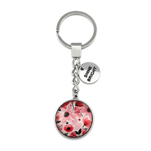 Circle pendant keychain in vintage silver with 'shine bright' charm, pop pink floral print. Fundraiser for the national breast cancer foundation.