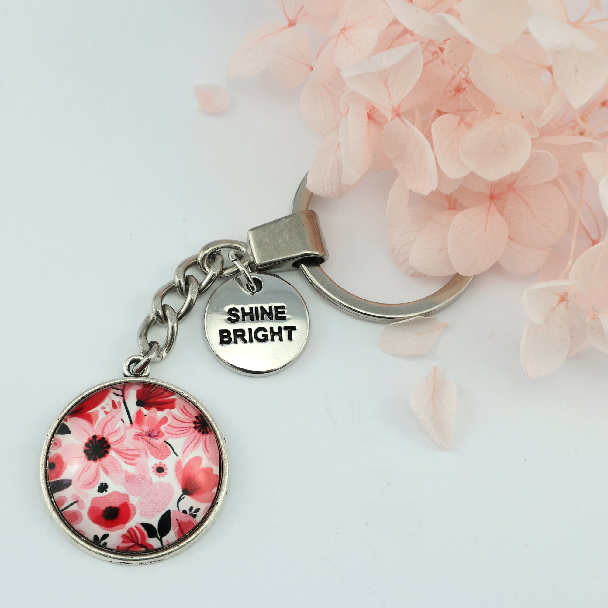 Circle pendant keychain in vintage silver with 'shine bright' charm, pop pink floral print. Fundraiser for the national breast cancer foundation.